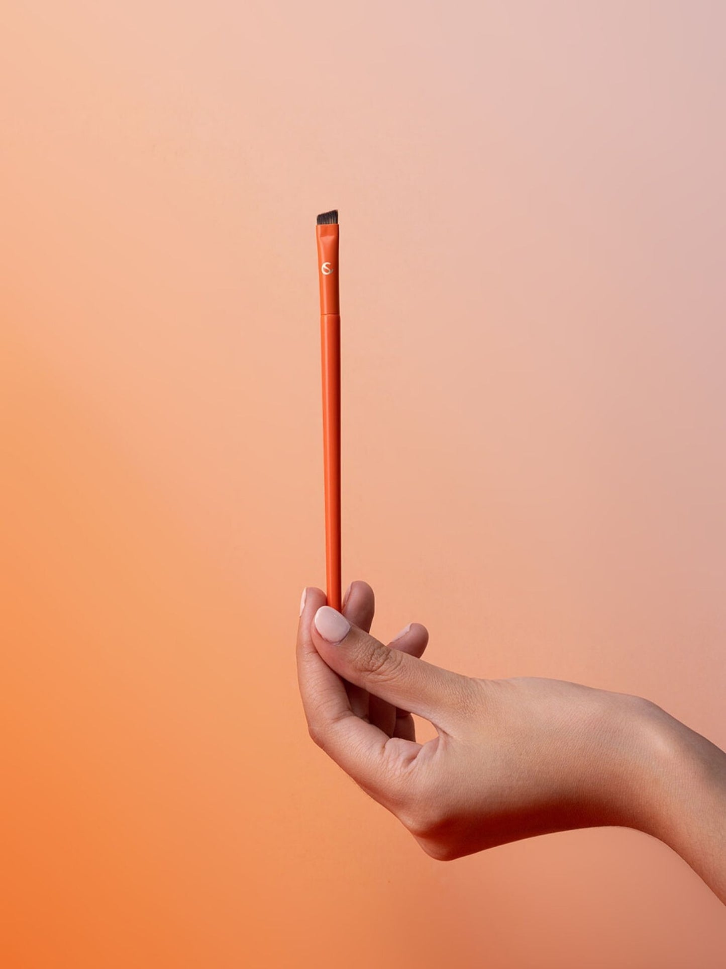 Hand holding the angled brow brush